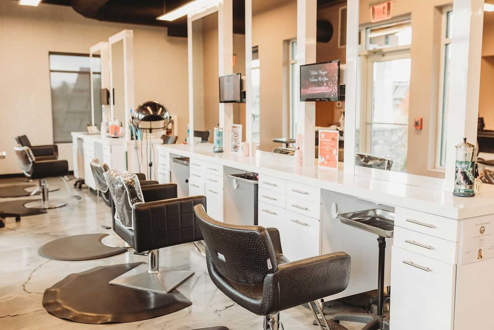 Modern hair salon interior with empty chairs and mirrors.